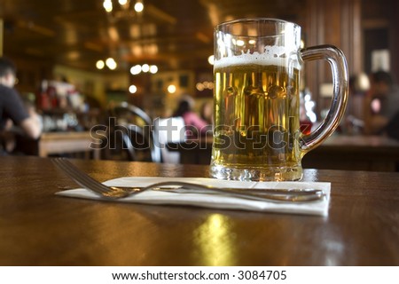 glass of beer on the table in pub close up