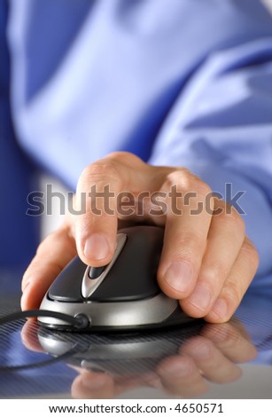 male business man hand on a computer mouse close up