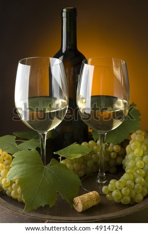 two glasses of white wine with grapes