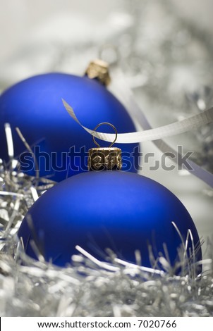 blue christmas ornaments with ribbon close up shoot
