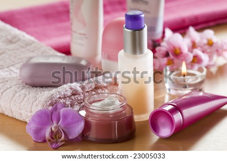 Cream, soap towels and orchid close up