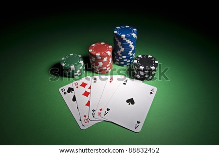 Poker cards and chips on green background close up