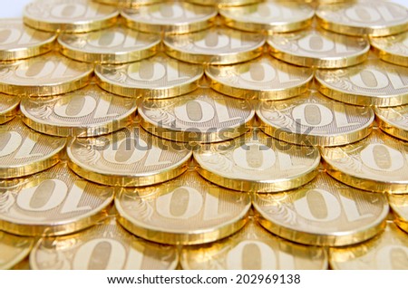 Shiny, yellow coins orderly arranged on the plane.