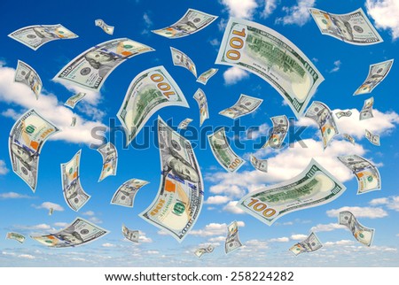 Hundred-dollar bills flying in the sky.