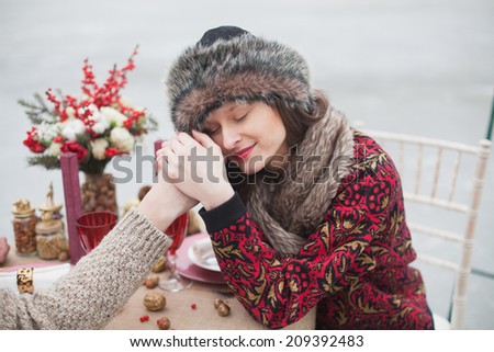 beautiful girl in the park in winter, in a fur cap on a romantic dinner