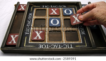 old hand playing game on an old board