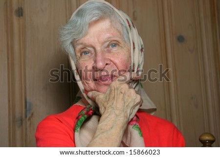 older woman in scarf with a slight smile on her face