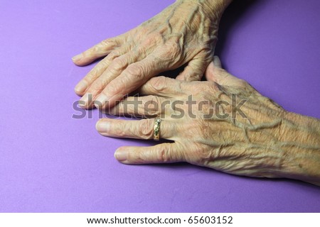 wrinkled hands of a ninety year old woman