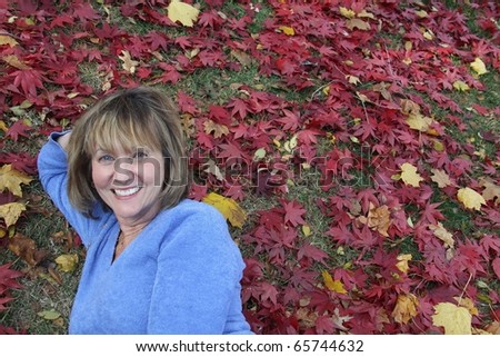 pretty woman having fun in the fall leaves