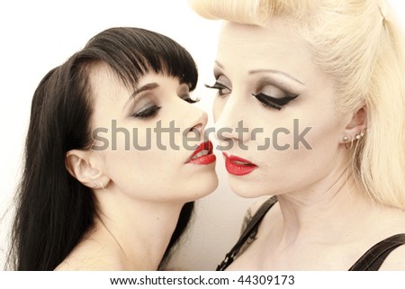 a stunning woman being seduced by another woman.