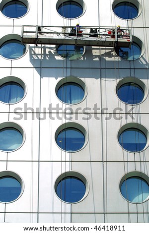 Men cleaning windows on a Tall building in Hong Kong.