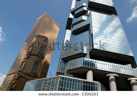 Golden business building, reflection building and blue sky