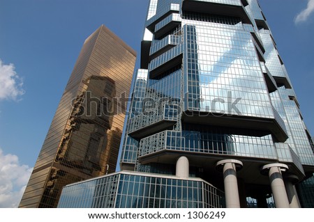 Golden business building, reflection building and blue sky