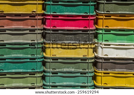 Stacked colorful plastic boxes on a fishing boat