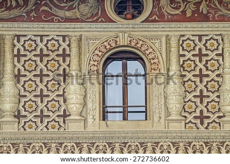 Vigevano - Detail view of a Renaissance palace with sand-colored facades and eggplant-colored paintings