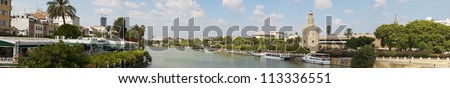 Panoramic photo of the Torre del Oro (Golden Tower) and the Guadalquivir river. The capital city Sevilla. Andalusia. Spain.