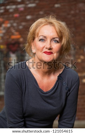 https://image.shutterstock.com/display_pic_with_logo/521287/121054615/stock-photo-middle-aged-good-looking-woman-urban-fashion-121054615.jpg