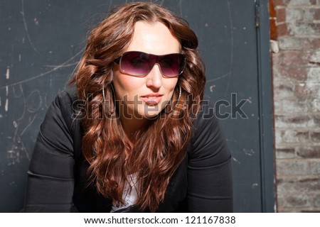 Pretty young woman in urban fashion style. Cool looking.