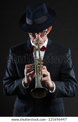 Senior jazz musician. Trumpet player. Studio shot.