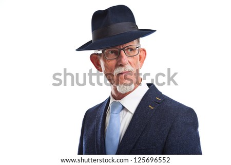 Serious well dressed senior man with hat. Isolated.