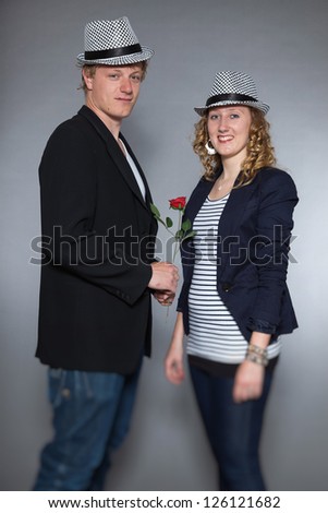 Young couple in love holding red rose. Man and woman.