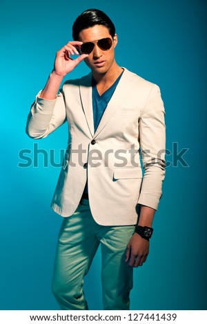 Asian man wearing suit and sunglasses. Summer fashion. Studio.