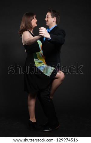 Romantic happy young couple dancing together. Stylish dressed.