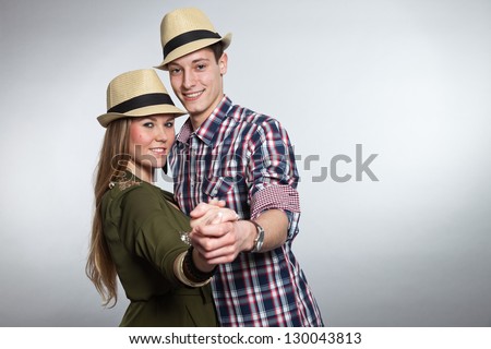Dancing young couple in love. Man and woman. Studio shot.