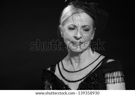 Vintage glamour studio portrait of senior woman. Black and white.