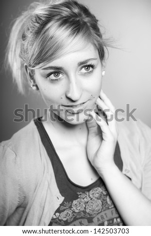 Fashion beauty studio portrait of pretty girl with long blonde hair. Black and white shot.