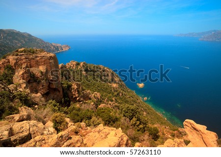 Mountain landscape with red rocks, blue ocean and blue sky, Corsica, France