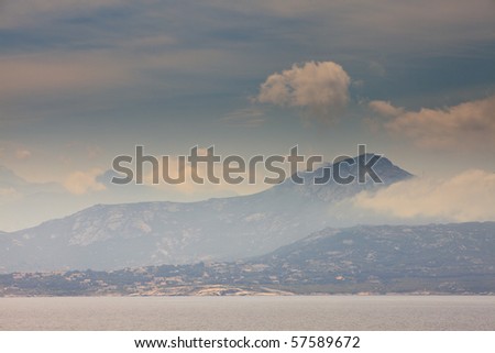 Big mountains with cloudy sky and ocean, Corsica, France