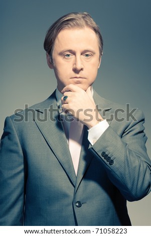 Vintage studio portrait of a serious young business man. Thinking. In thought. In mind. Concentration. Boss. Power. Old photo.