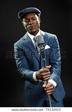 Black man with blue striped suit and cap singing. Jazz musician. Night ...