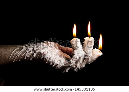 Three candle sticks on fingers bunring with wax flow artistic conversion