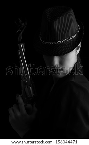 Dangerous woman in black with silver smoking handgun and stylish hat artistic conversion