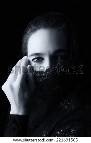 Middle Eastern woman portrait looking sad with a black hijab artistic conversion