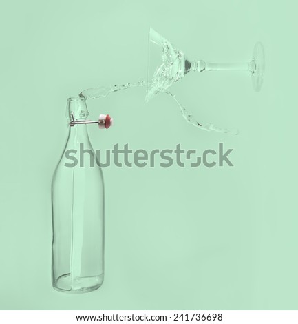 Clear water pour horizontal out of bottle splash into a glass with green back lighting