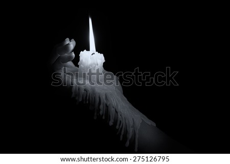 Open hand holding a candle stick with wax flowing down the arm artistic conversion