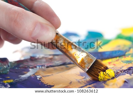 Somebody is painting some picture with paintbrush, isolated on white background