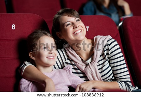 Mother with daughter enjoying time in the movie