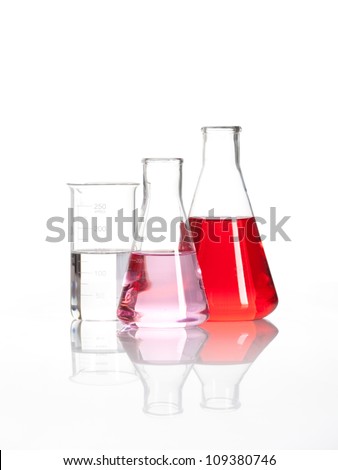 Laboratory flasks - Clear liquid mixed with a red colored chemical reagent, isolated