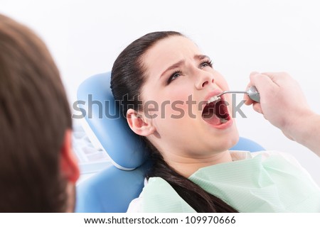 Dentist rinses the oral cavity of the patient on the dentist\'s chair