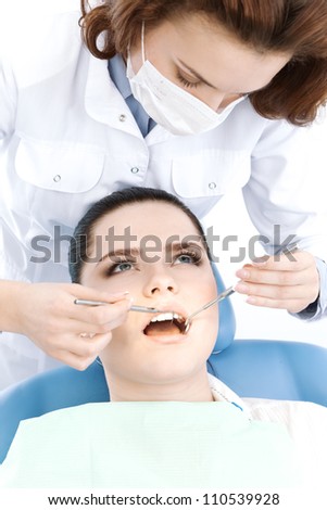 Assistant checks up the teeth of the patient