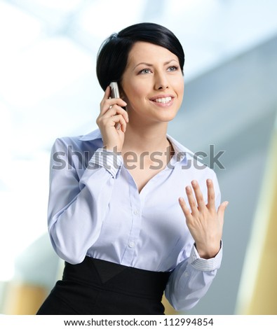 Business woman in business suit talks on telephone. Leadership