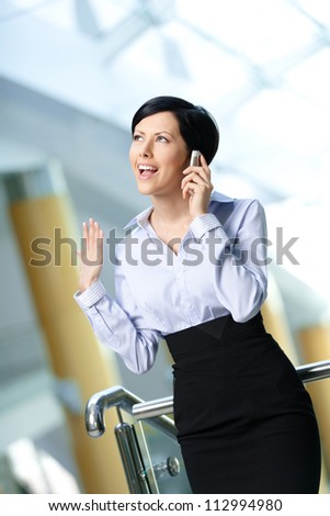 Business woman in business suit talks on telephone. Communication