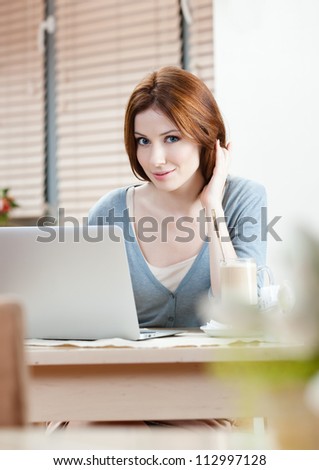 Lady is surfing on the internet on the personal computer