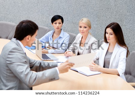 CEO holds a business meeting with his employers at business center