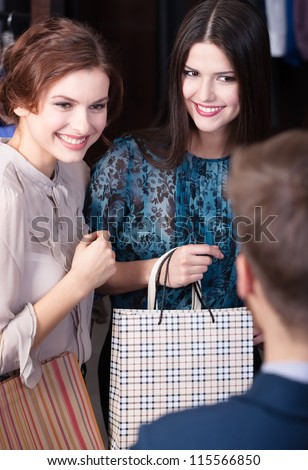 Shop assistant gives a piece of advice to beautiful clients