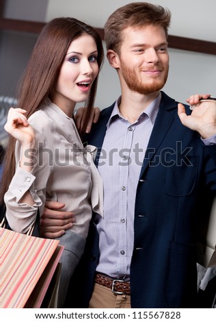Wondered woman with her pleased boyfriend is in the shop
